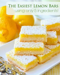 several pieces of cake sitting on top of a white plate next to an orange and some lemons