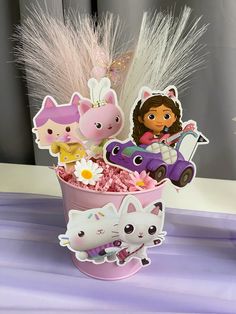 a pink cup filled with lots of toys