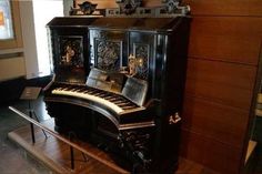 an old piano is on display in a museum