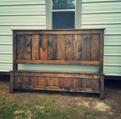 a wooden bench sitting in front of a house