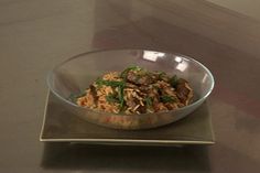 a bowl filled with food sitting on top of a table