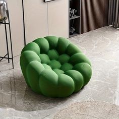 a green chair sitting on top of a white floor