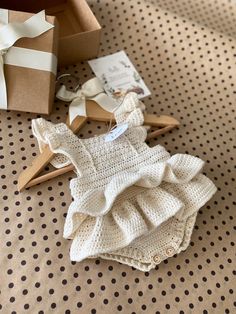 a baby's diaper is laying on the floor next to a gift box