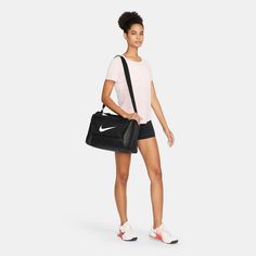 Good things come in small packages, especially when that package is the Nike Brasilia Duffel Bag. Fill it with your gear and stay organized on your next trip to the gym or a daytime adventure. A side compartment stores shoes and sweaty clothes separately, while inner and outer pockets help you stay organized. This product is made with at least 50% recycled polyester fibers. Adjustable shoulder strap. Zippered main compartment secures your training essentials. Zippered inner compartment keeps dir Nike Sports Bag, Training Bags, Work Wear Women, Sport Soccer, Nike Tees, Sport Bag, Work Shirts, Shoe Store, Duffel Bag