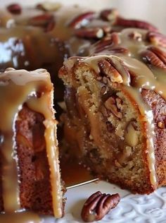 a bundt cake with pecans and icing on top