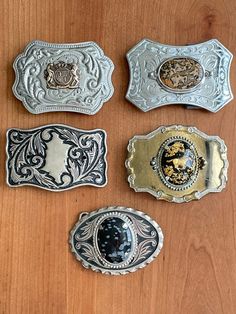 From the estate of a collector, 5 western-style belt buckles. Free shipping in the US. #1 - punched tin with bronze horse crest (identify unknown) #2 - embossed silver alloy with brown agate  #3 - antiqued silver alloy with fronds #4 - gold alloy with lucite center cabochon featuring gold horse and gold leaf flake. Some light scratches, see pics.  #5 - antiqued silver alloy with black and grey cabochon  All show light wear but in good, wearable condition. Please see pics for details. On orders o Old Worn Metal Buckle, Luxury Vintage Silver Belt Buckles, 70s Belt Buckle, Vintage Engraved Belt Buckles Collectible, Vintage Engraved Belt Buckles For Collectors, Silver Belt Buckles For Western-themed Events, Vintage Engraved Brown Belt Buckles, Vintage Brown Engraved Belt Buckles, Vintage Engraved Antique Silver Belt Buckles