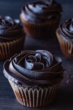 chocolate cupcakes with frosting on a table