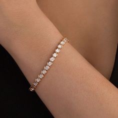 Wear this smart diamond tennis bracelet any time for a great touch of classic dazzle. Crafted in sterling silver with 14K rose gold plate, this enticing design features shimmering diamonds - artfully set to enhance size and sparkle - and beaded circles alternating with polished "S" shaped links. Captivating with 1/10 ct. t.w. of diamonds and a bright polished shine, this 7.25-inch bracelet secures with a tongue and groove clasp. Rose Gold Diamond Tennis Bracelet With Prong Setting, Elegant Rose Gold Cubic Zirconia Tennis Bracelet, Rose Gold Diamond Tennis Bracelet With Jubilee Style, Rose Gold Diamond Tennis Bracelet Brilliant Cut, Rose Gold Diamond Bracelet With Vvs Clarity, Everyday Luxury Rose Gold Cubic Zirconia Tennis Bracelet, Anniversary Rose Gold Tennis Bracelet With Brilliant Cut, Elegant Rose Gold Tennis Bracelet For Anniversary, Fine Jewelry Rose Gold Tennis Bracelet With Prong Setting