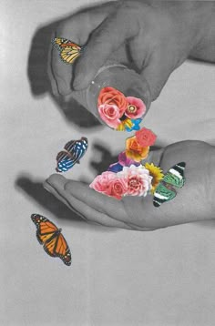 two hands with flowers and butterflies on them, one is holding the other's fingers