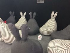 several stuffed animals sitting on bean bags in the shape of bunnies and zebras