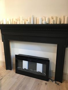 a fire place with candles on the mantle