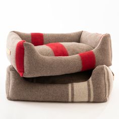 the cat bed is made out of gray and red striped material