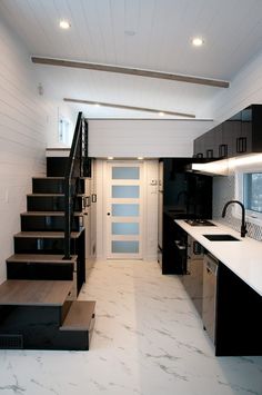 a kitchen with stairs leading up to the door