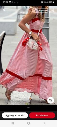 a woman in a red and white dress is walking down the street with her hand on her hip