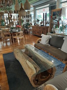 a living room filled with furniture and lots of wood pieces on top of a wooden floor