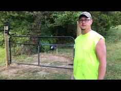 a man standing in front of a fence with an animal on it's side