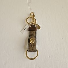 a keychain with a metal ring attached to it on a white tablecloth