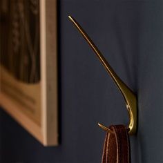 a pair of scissors hanging on the side of a wall next to a towel rack