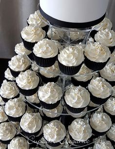 cupcakes are stacked on top of each other in the shape of a wedding cake