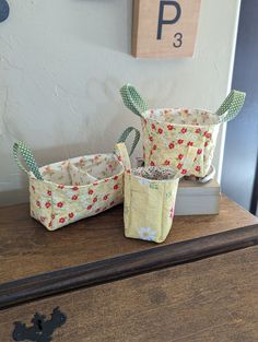 three baskets sitting on top of a wooden table