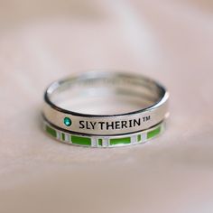 Be proud and ambitious with this NEW Slytherin™ House Ring Stack, featuring a gentle silver band with Slytherin™ etched on the front, and “ambition, pride, cunning” on the inside, as well as a second band inspired by the Slytherin™ scarf! For every ring stack sold, Pura Vida will donate 5% of the purchase price to the World Literacy Foundation, with a maximum donation of $25,000. Your donations will help further the World Literacy Foundation’s mission to ensure that every child—regardless of geo Slithering Gifts, Gifts To Get A Slytherin, Dracos Ring, Slytherin Ring, Slytherin Stuff, Theodore Nott, Slytherin House, Pura Vida Bracelets, Ring Stack