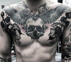 a man with tattoos on his chest and shoulder