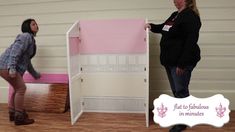 two women standing next to each other in front of a pink bed with white walls