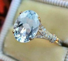 an oval blue topaz ring with diamond accents