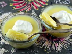 two small bowls filled with pudding and whipped cream