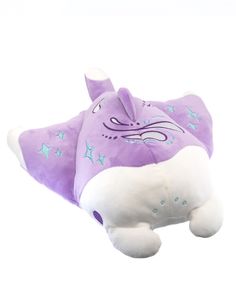 a purple stuffed animal with stars on it's back and its tail laying down