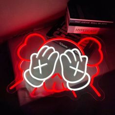 a neon sign with two hands on it