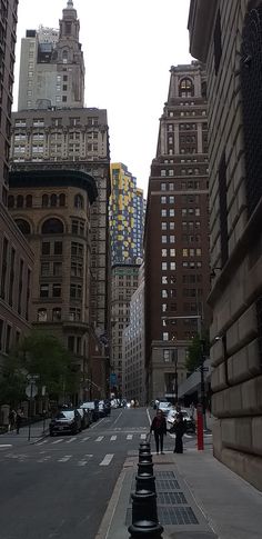 the city street is lined with tall buildings