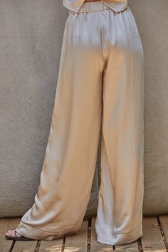 Pearl Pants Satin wide leg trousers in a beautiful pearl color. Very elegant and classic. Elastic in the waist, with clasp and zipper and side pockets. Wear it with the Pearl Blouse or with another top. The fabric is a blend of polyester and spandex, hand wash cold, no bleach, hang dry, no iron. Wide Satin Pants Outfit, Silky Pants Outfit, Silk Trousers Outfit, Satin Trousers Outfit, Flowy Silk Pants, White Satin Pants, Satin Pants Outfit, Pearl Pants, Modest Pants