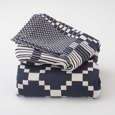 two blankets folded on top of each other in checkered pattern, one blue and the other white