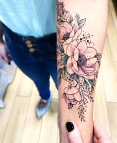 a woman's arm with flowers on it and the words instagramn above her