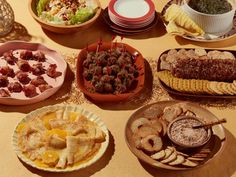 a table topped with plates and bowls filled with food