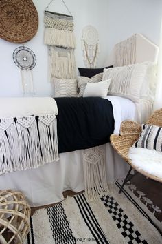 a bedroom with white and black decor on the walls, rugs and bedding