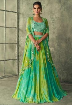 Readymade Faux Georgette Lehenga in Sea Green and Yellow This attire with Poly Shantoon Lining is Enhanced with Resham, Zari, Sequins, Mirror and Patch Border Work Available with a Art Silk Sea Green Sleeveless Choli Crafted in Round Neckand a Jacket Style Faux Georgette Dupatta. The Choli, Jacket and Lehenga Lengths are 16 to 17, 38 and 44 inches respectively Do Note: Accessories shown in the image are for presentation purposes only. (Slight variation in actual color vs. image is possible). Party Wear Skirt Top, Mehandi Outfits, Mehendi Outfit, Haldi Outfits, Cocktail Skirts, Trendy Outfits Indian, Mehendi Outfits, Georgette Lehenga, Yellow Lehenga