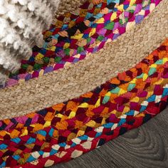 multi colored braided rugs laying on top of each other