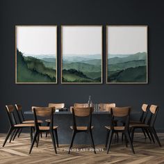 a dining room table with chairs and paintings on the wall