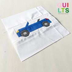 a piece of white fabric with a blue car on it