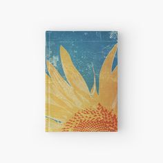 a sunflower with blue sky and clouds in the background hardcover book cover on a white surface