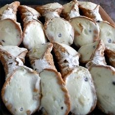 some type of bread that is cut in half and covered with powdered sugar on top