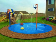 a blue and yellow play ground with a water sprinkler