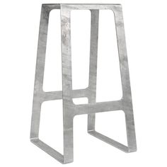 a metal stool that is standing up against a white background