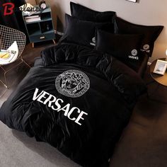 a black bed with versa written on it in a room next to a chair and table