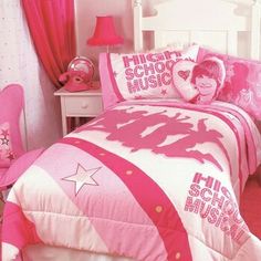 a bedroom with pink and white bedding and curtains