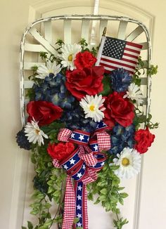 a patriotic wreath with red, white and blue flowers