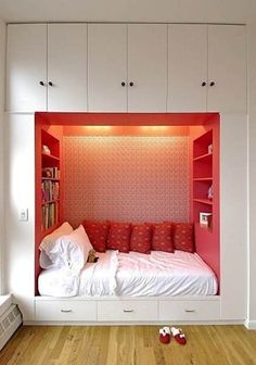 a bedroom with a bed and built in bookshelves