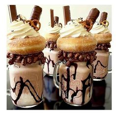 three glasses filled with ice cream and chocolate covered doughnuts on top of each other